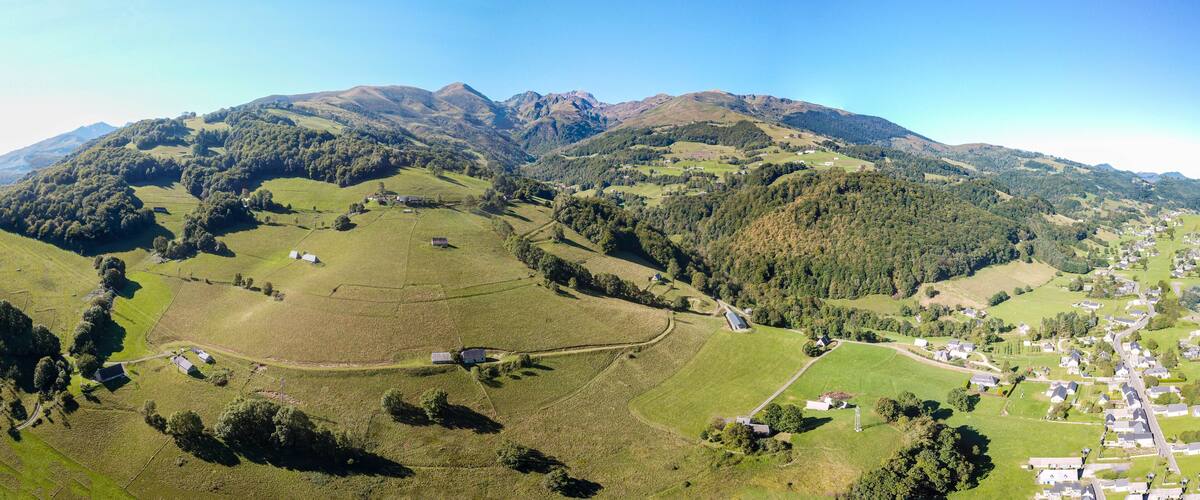 A mountainous landscape with a village nestled in the valley.