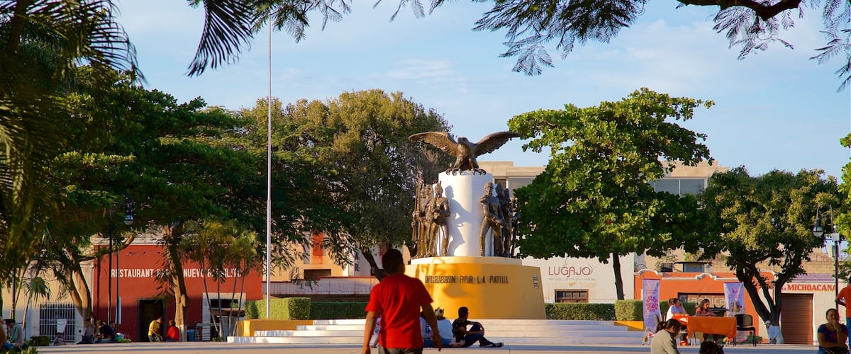 Parque de La Mejorada which includes a statue or sculpture and a park as well as an individual male