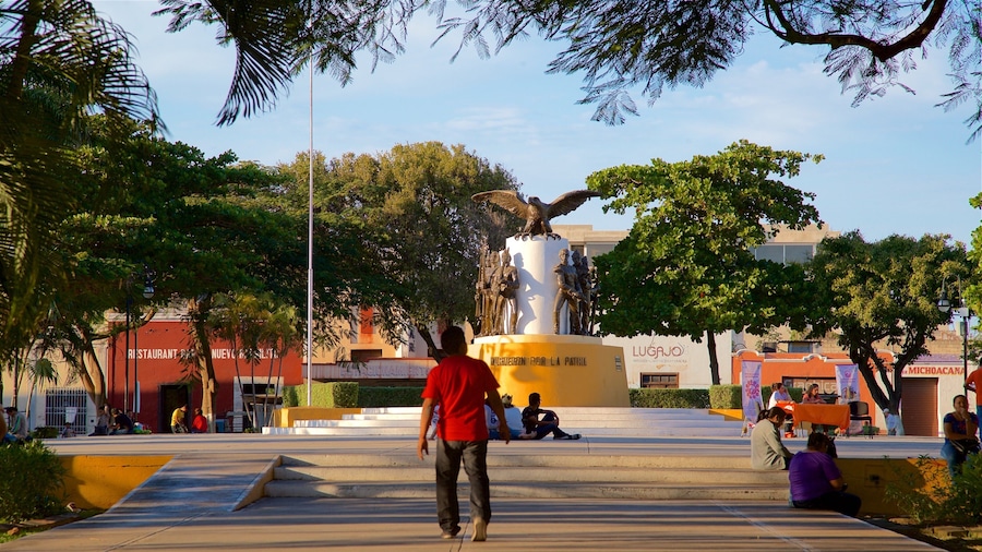 Parque de La Mejorada which includes a statue or sculpture and a park as well as an individual male