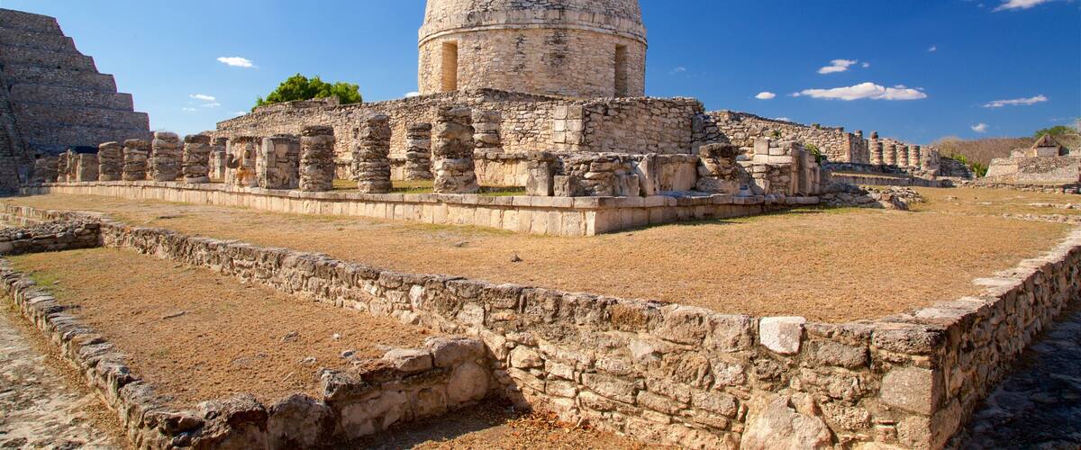 Ancient ruins with stone structures and a large central tower.