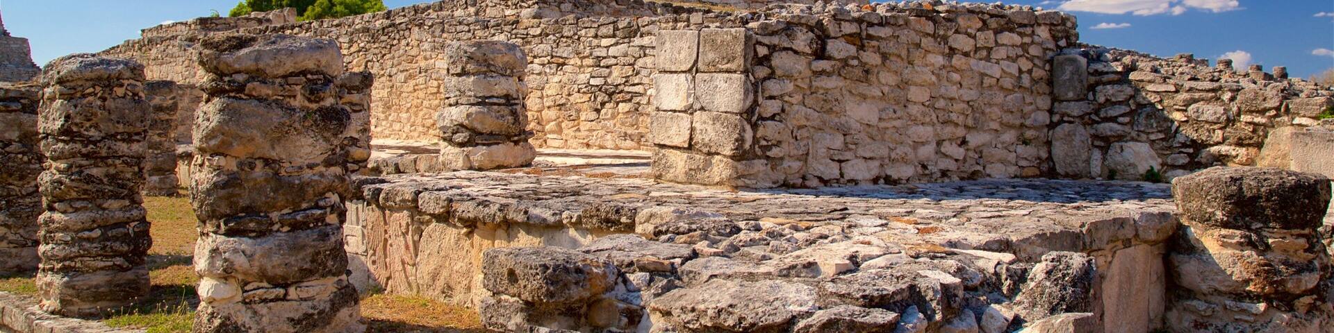 Ancient stone ruins with a large cylindrical tower.