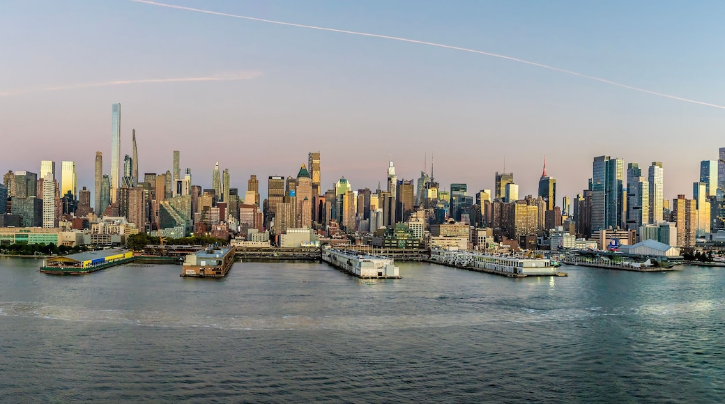 A panorama view approaching dusk from the Hudson River across the skyline of Manhattan, New York, in the fall