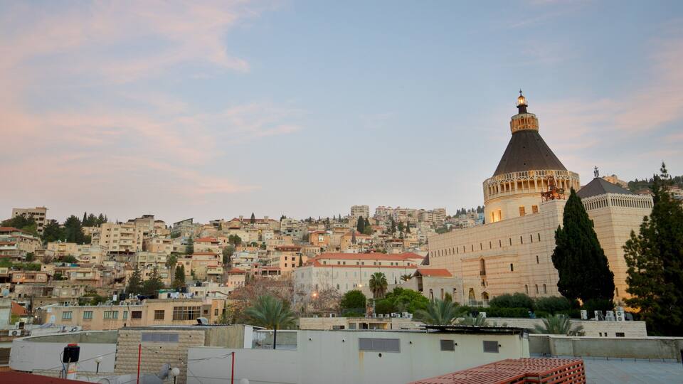 A cityscape with a prominent tower and a mosque with a dome.