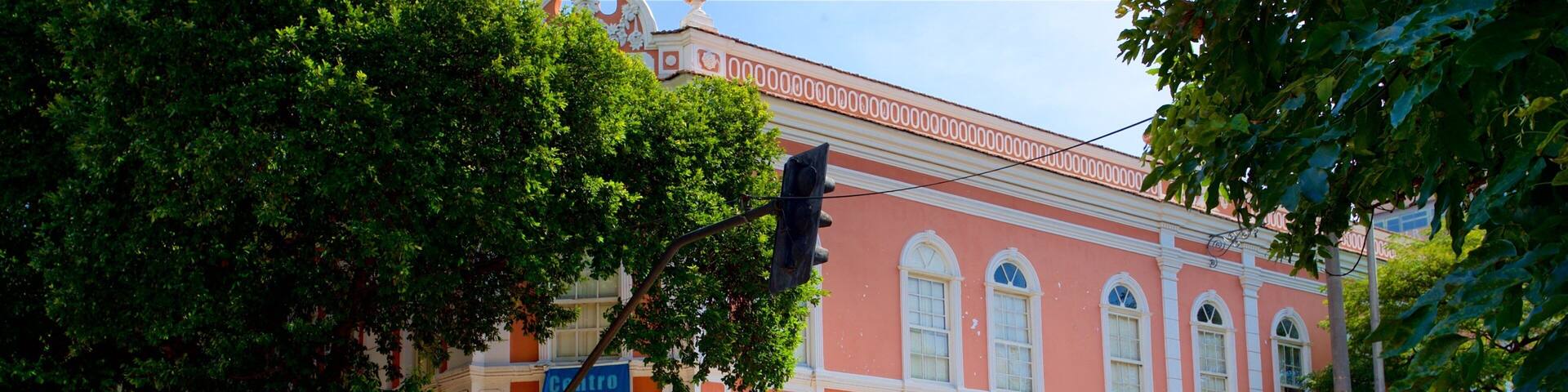 A historic building with arched windows and a red facade.