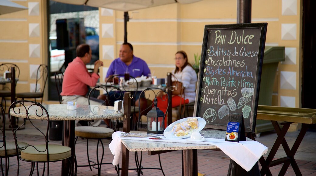 Hidalgo Park showing signage and outdoor eating as well as a small group of people