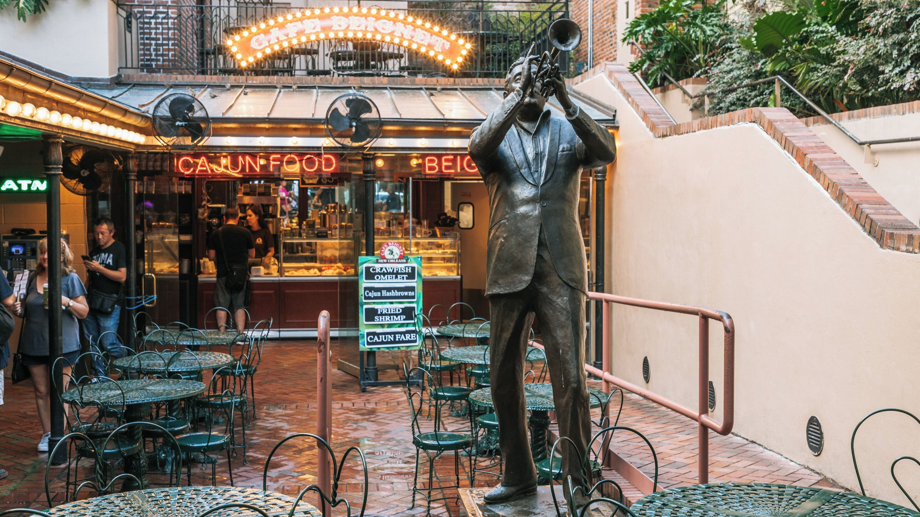 Musical statues and vibrant dining in New Orleans Musical Legends Park showcase the city's rich cultural heritage and love for music and cuisine