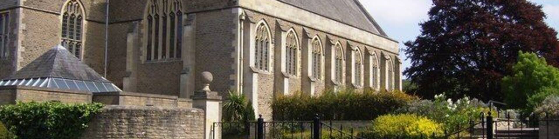 A stone church with a pointed roof and arched windows.