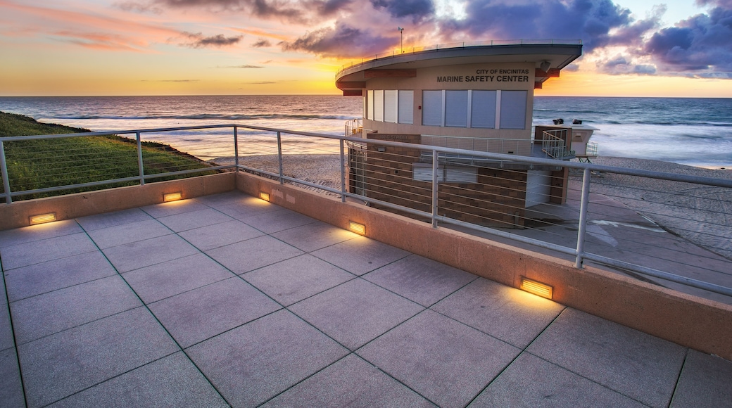 A lifeguard tower at the City of Encinitas Marine Safety Center with a view of the ocean at sunset.