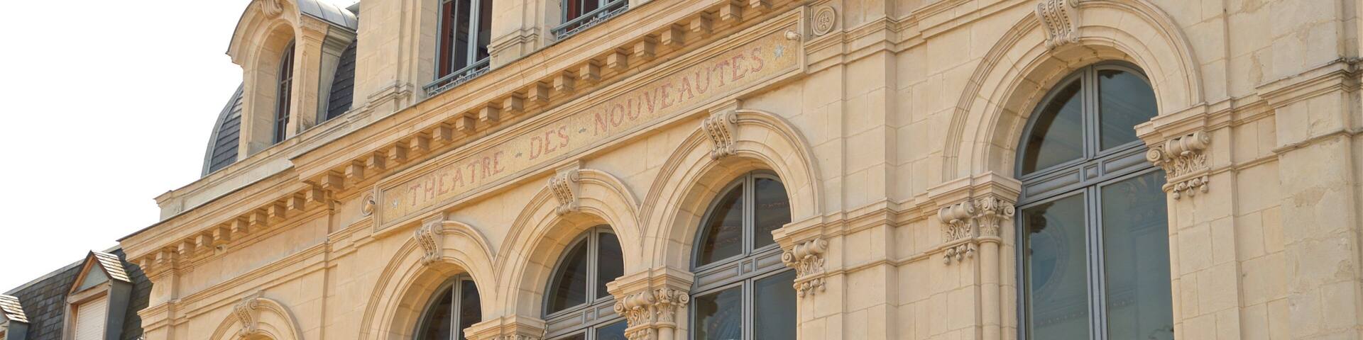 A historic building with ornate architectural details, including arched windows and decorative stonework.