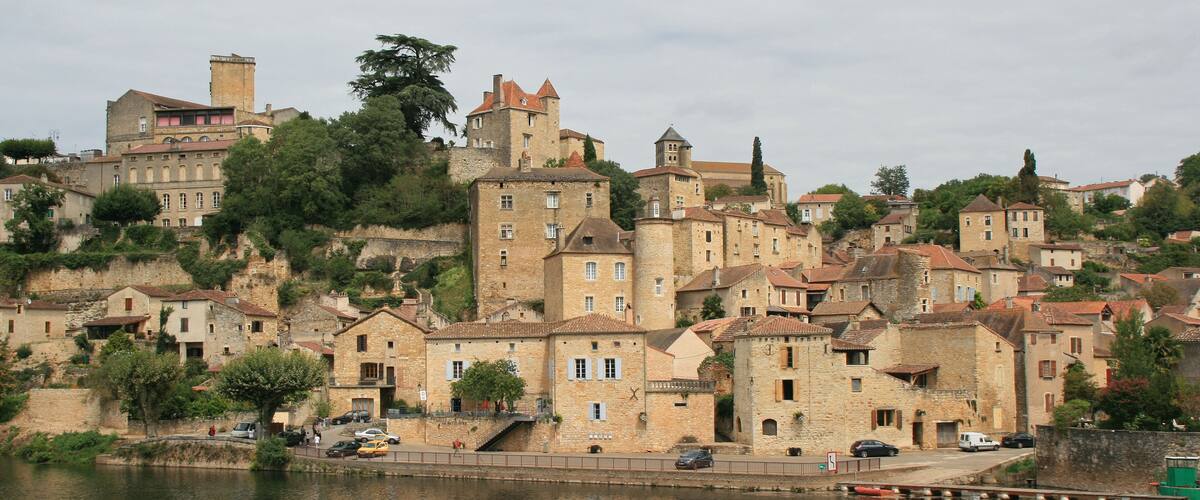 A historic town with medieval architecture by a river.