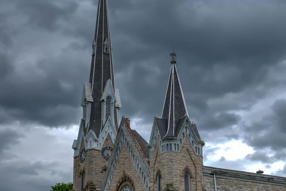 A historic church with two tall spires and large arched windows.