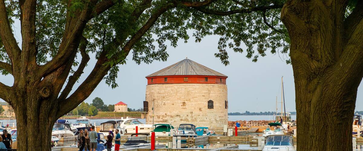 Kingston Waterfront showing heritage elements and a bay or harbor as well as a small group of people