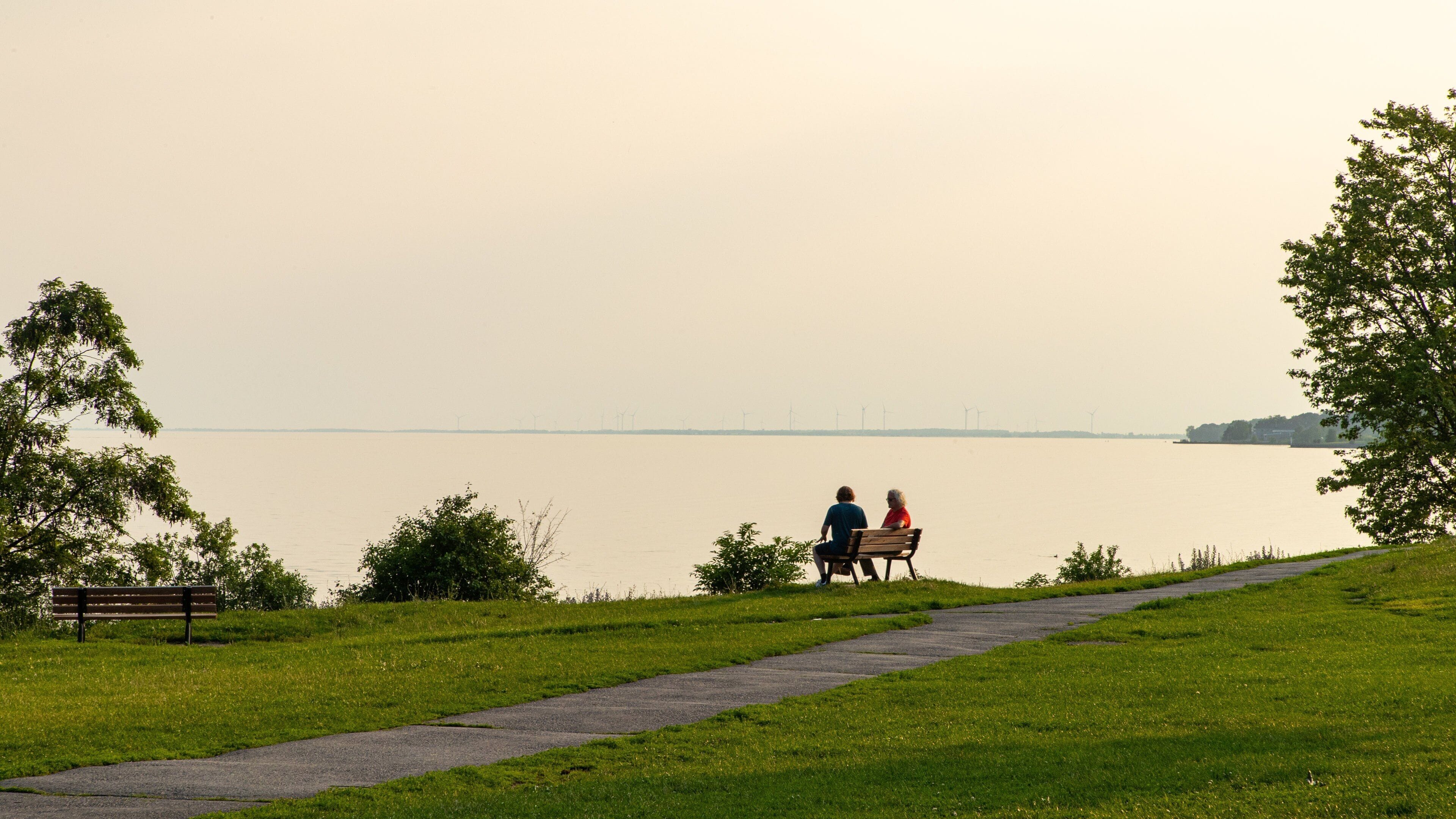 Kingston Waterfront featuring a lake or waterhole, a garden and a sunset