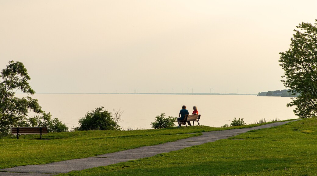 Kingston Waterfront featuring a lake or waterhole, a garden and a sunset