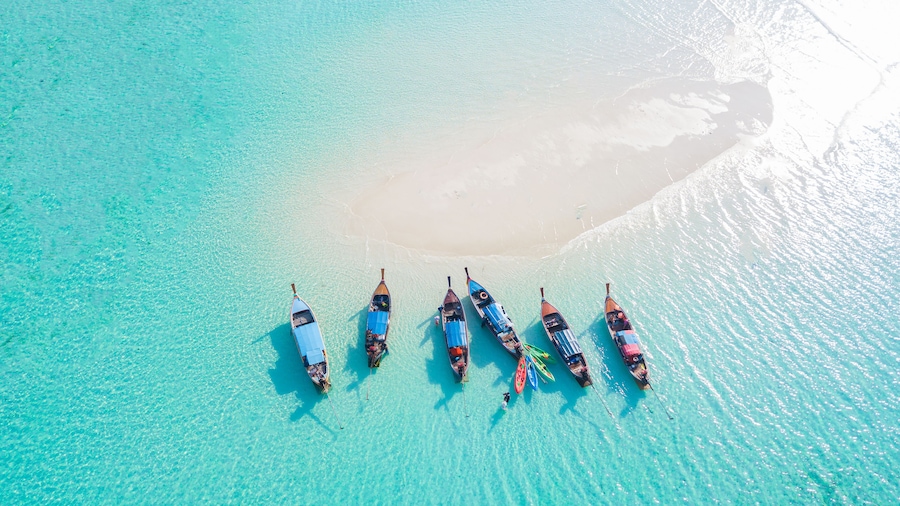 Top view or aerial view of Beautiful crystal clear water and white beach with long tail boats in summer of tropical island or Koh Lipe in Satun,Southern Thailand , Shutterstock ID 1256789458, Purchase