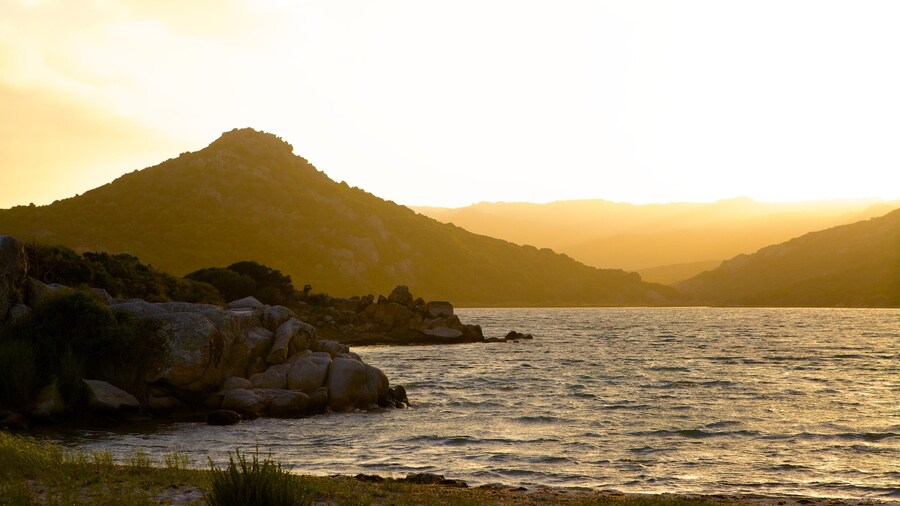 Balistra Beach which includes rocky coastline and a sunset