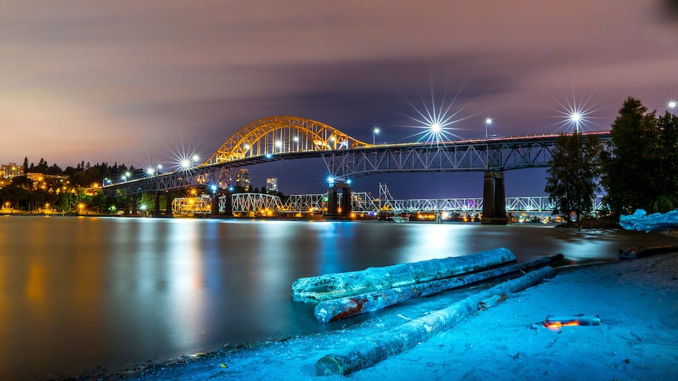 Patullo Bridge, Surrey, British Columbia, Canada. Long exposure of the bridge over the water. Sky Train Bridge.