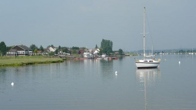 Brandy Hole Yacht Club and pontoon A still morning at Brandy Hole. Looking west up the river Crouch through the moorings.
