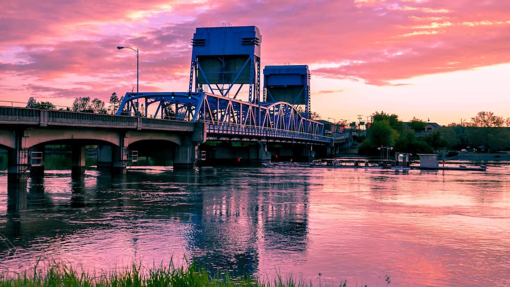 Lewiston - Clarkston blue bridge against vibrant twilight sky