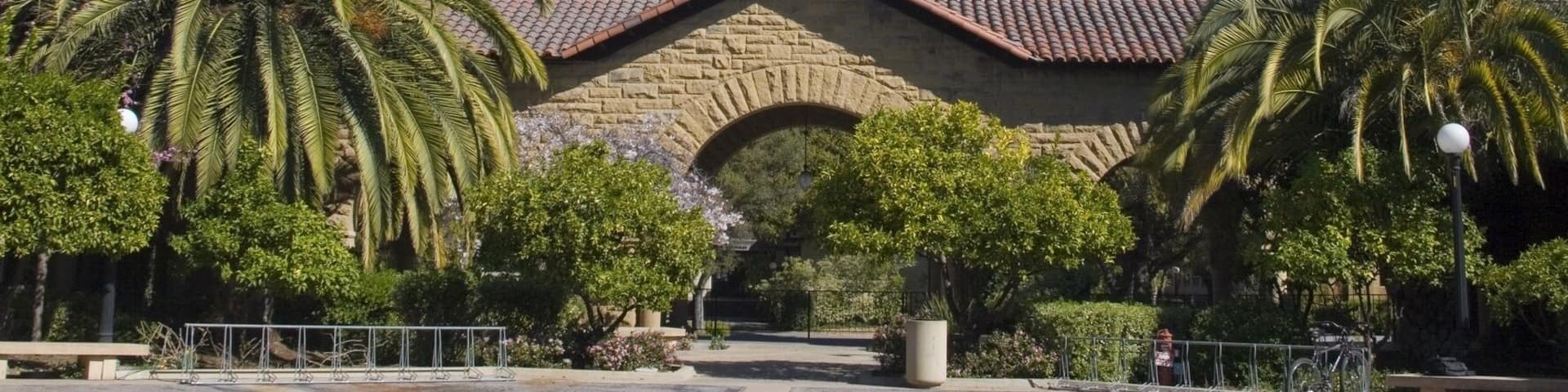 Hoover Tower overlooking a Stanford University courtyard with its sandstone archways and Spanish style architecture