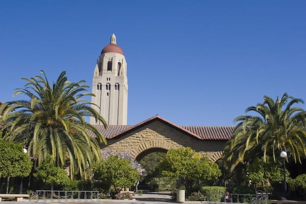 Hoover Tower overlooking a Stanford University courtyard with its sandstone archways and Spanish style architecture
