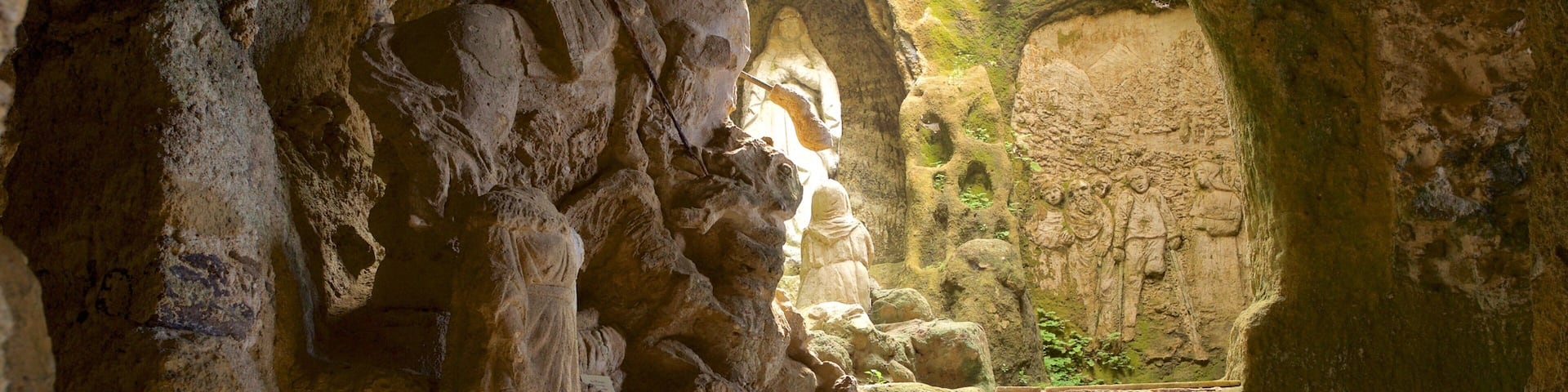 A cave with ancient rock carvings and a small window.