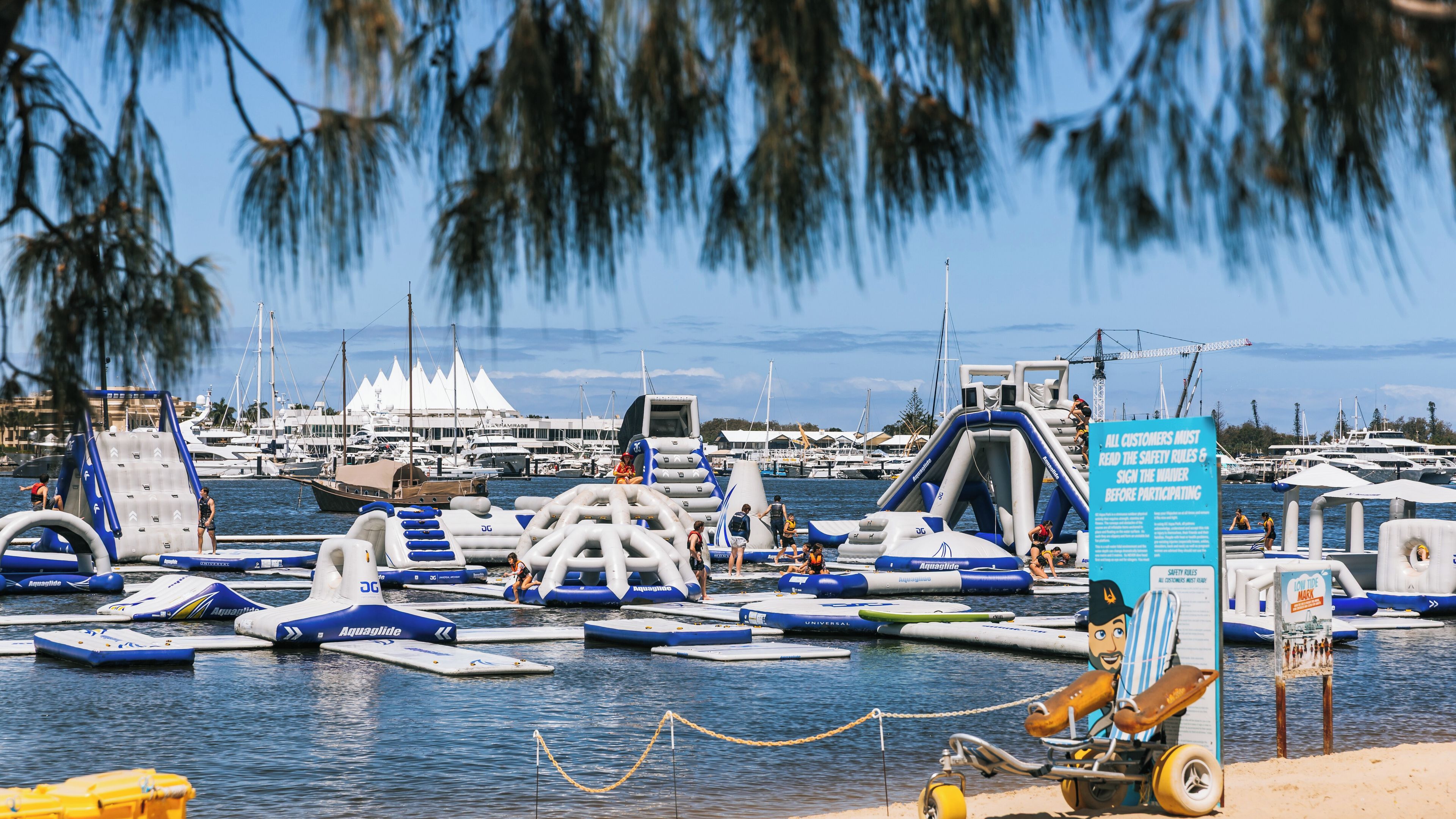A marina with inflatable watercraft and a signboard.