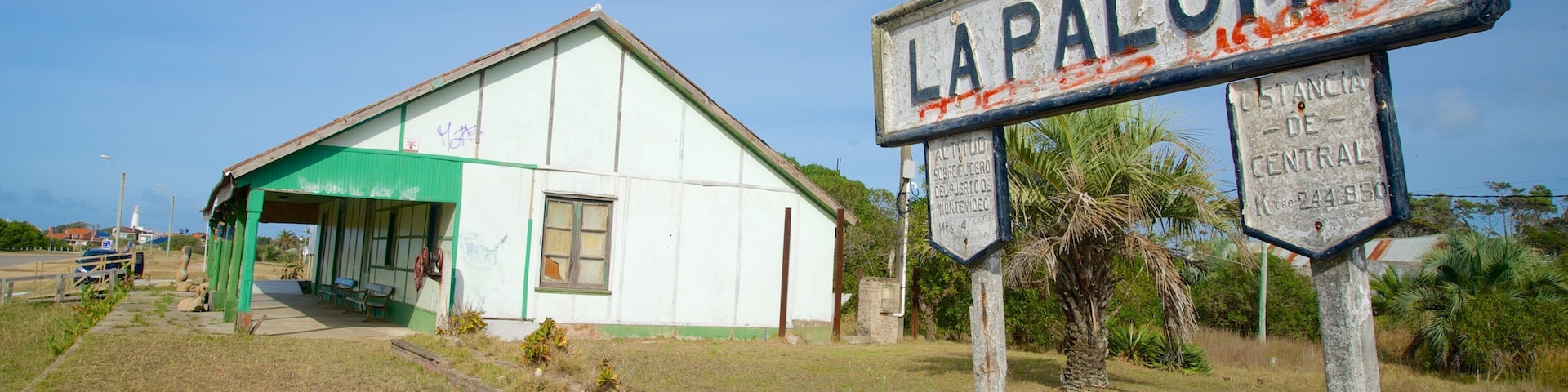 Old Train Station featuring signage and a small town or village