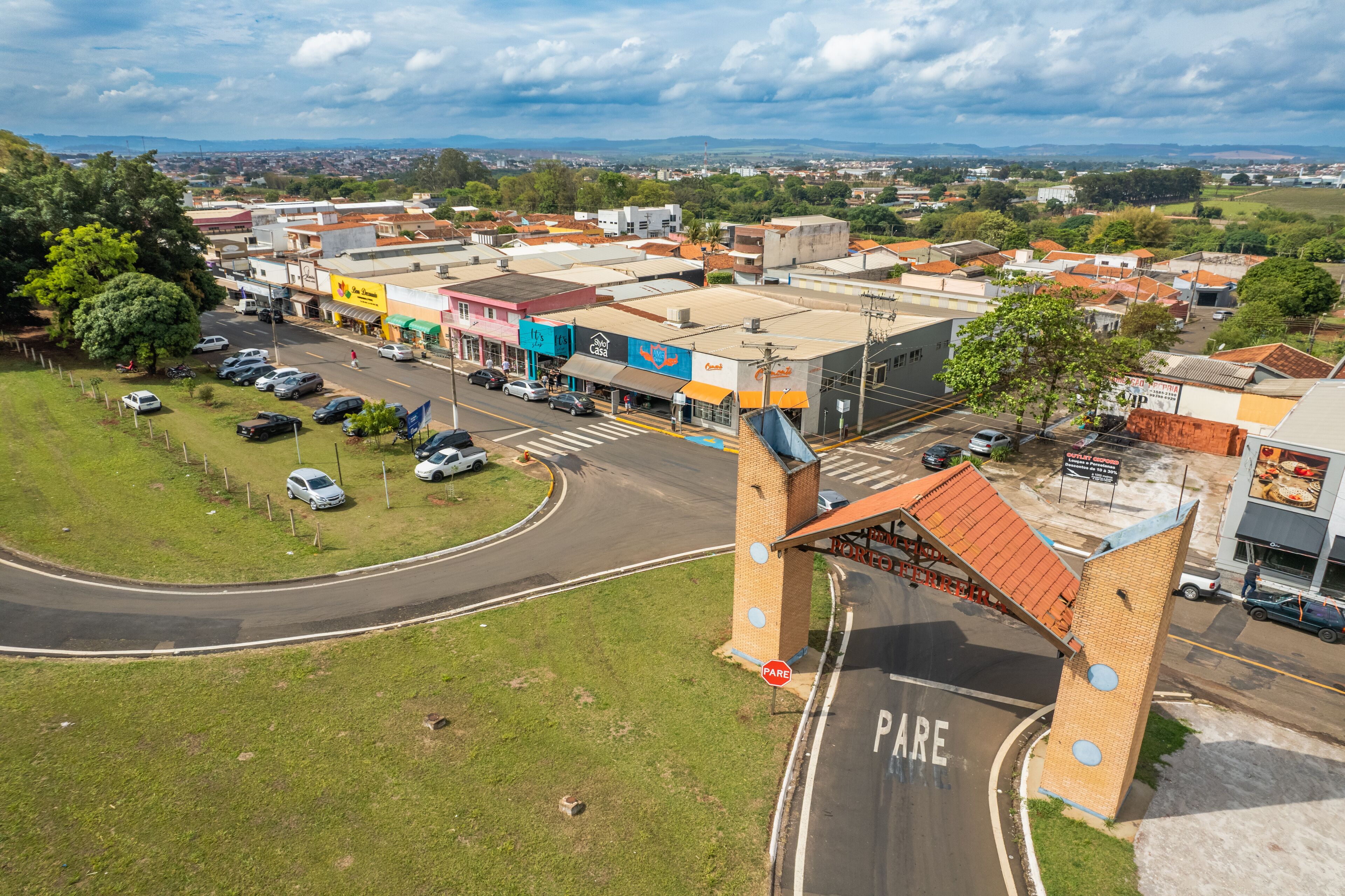 A town with a prominent bridge, a parking area, and various buildings including a restaurant.