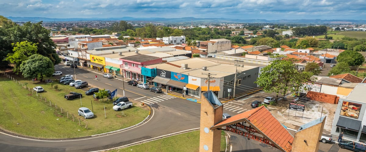A town with a prominent bridge, a parking area, and various buildings including a restaurant.