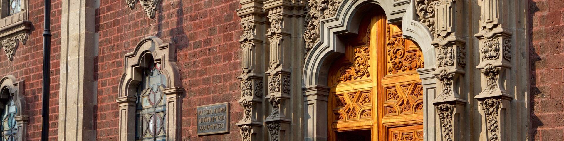A historic building with ornate wooden doors and detailed stone carvings.