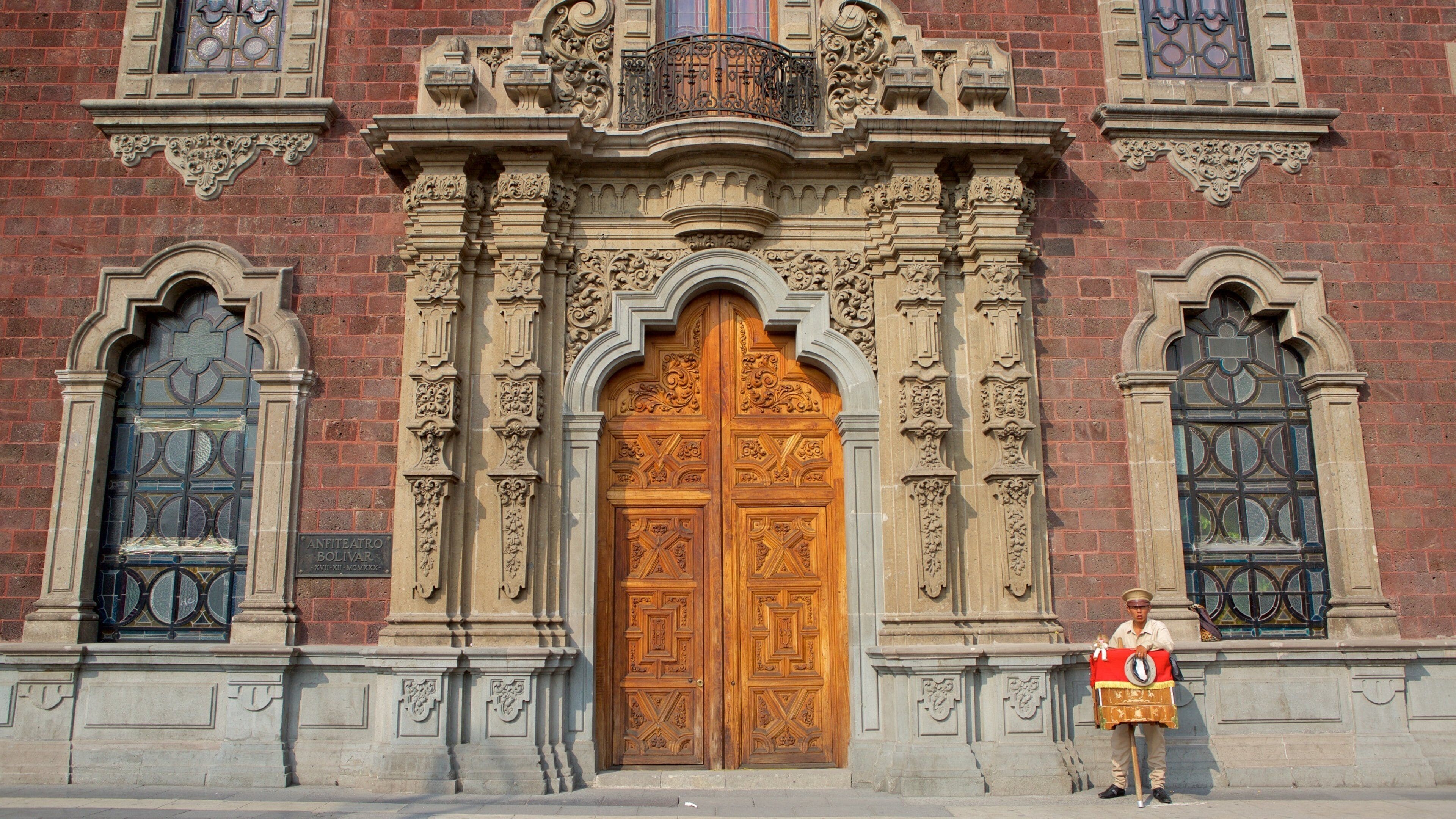 A historic building with ornate wooden doors and intricate stone carvings.