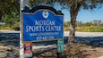 A blue sign for the Morgan Sports Center with a website and phone number.