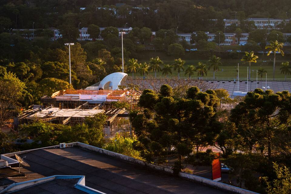 A stadium under construction surrounded by trees and buildings.