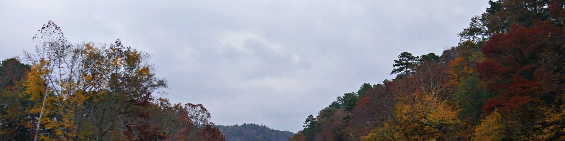 Panoramic view of colorful leaves of the trees along the Mountain Fork River at the Beavers Bend State Park in Broken Bow, Oklahoma
