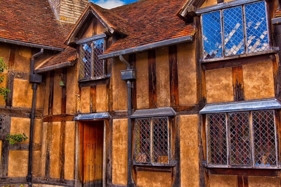 A traditional half-timbered house with exposed wooden beams and a tiled roof.