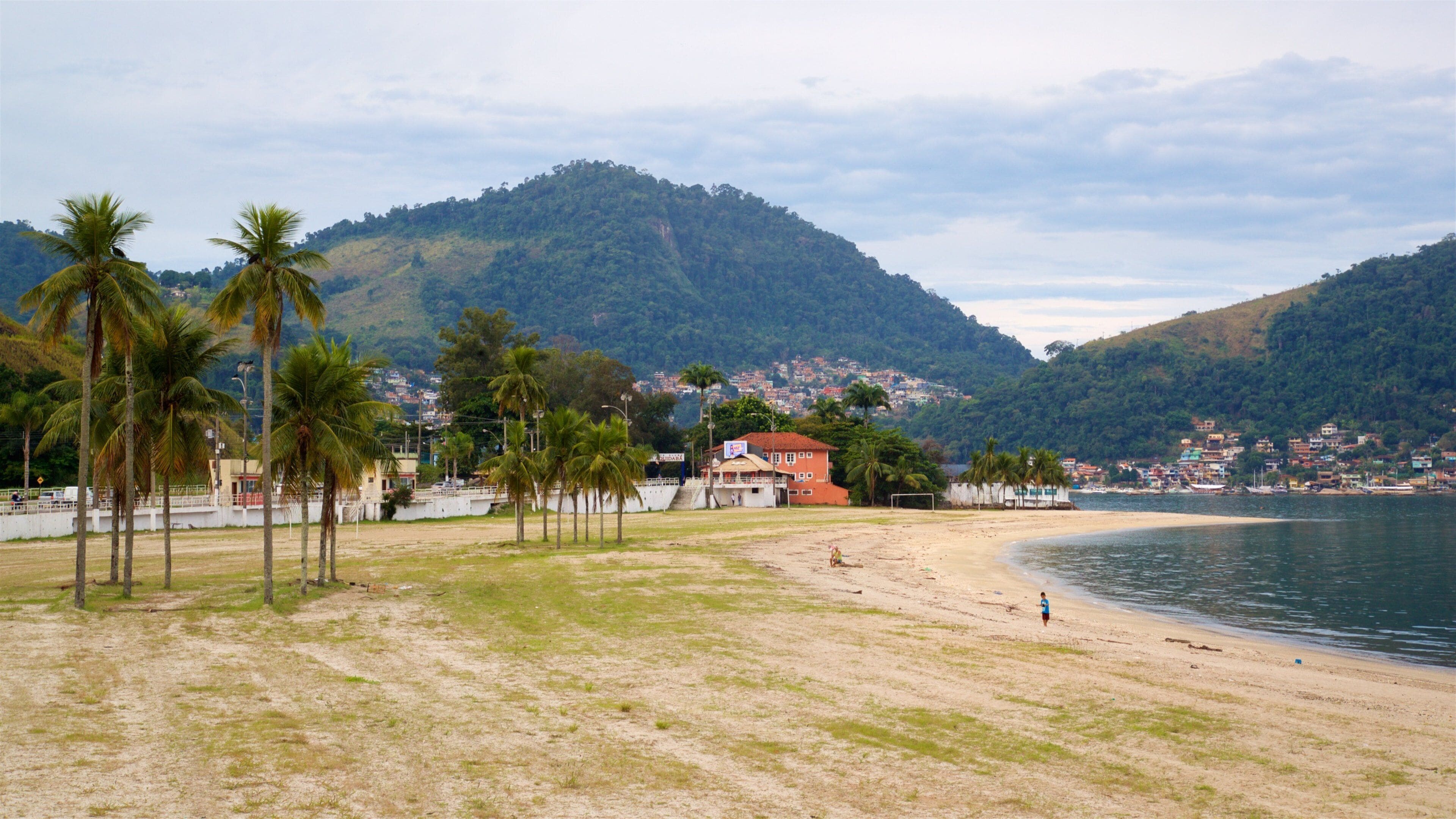 Anil Beach showing a coastal town, a lake or waterhole and tropical scenes