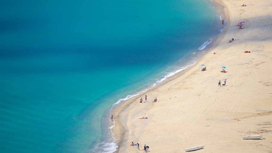 Caminia Beach which includes general coastal views and a sandy beach as well as a small group of people
