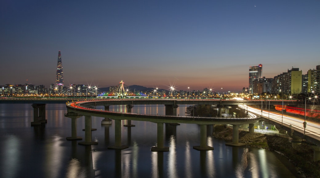 Gwangjin-gu, Seoul, South Korea - December 20, 2020: Night view of Cheonho Bridge and Gangbyeon Expressway on Han River with the background of Olympic Bridge and Lotte World Tower