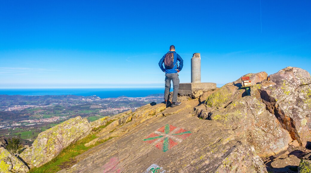A male hiker on the top of Mount Adarra in Urnieta. Gipuzkoa, Basque Country