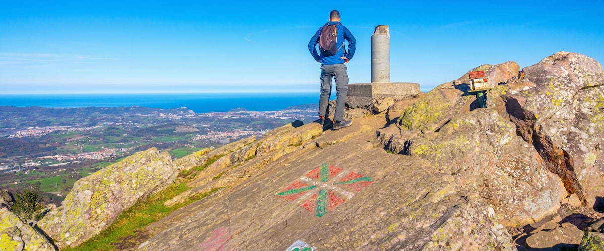 A male hiker on the top of Mount Adarra in Urnieta. Gipuzkoa, Basque Country