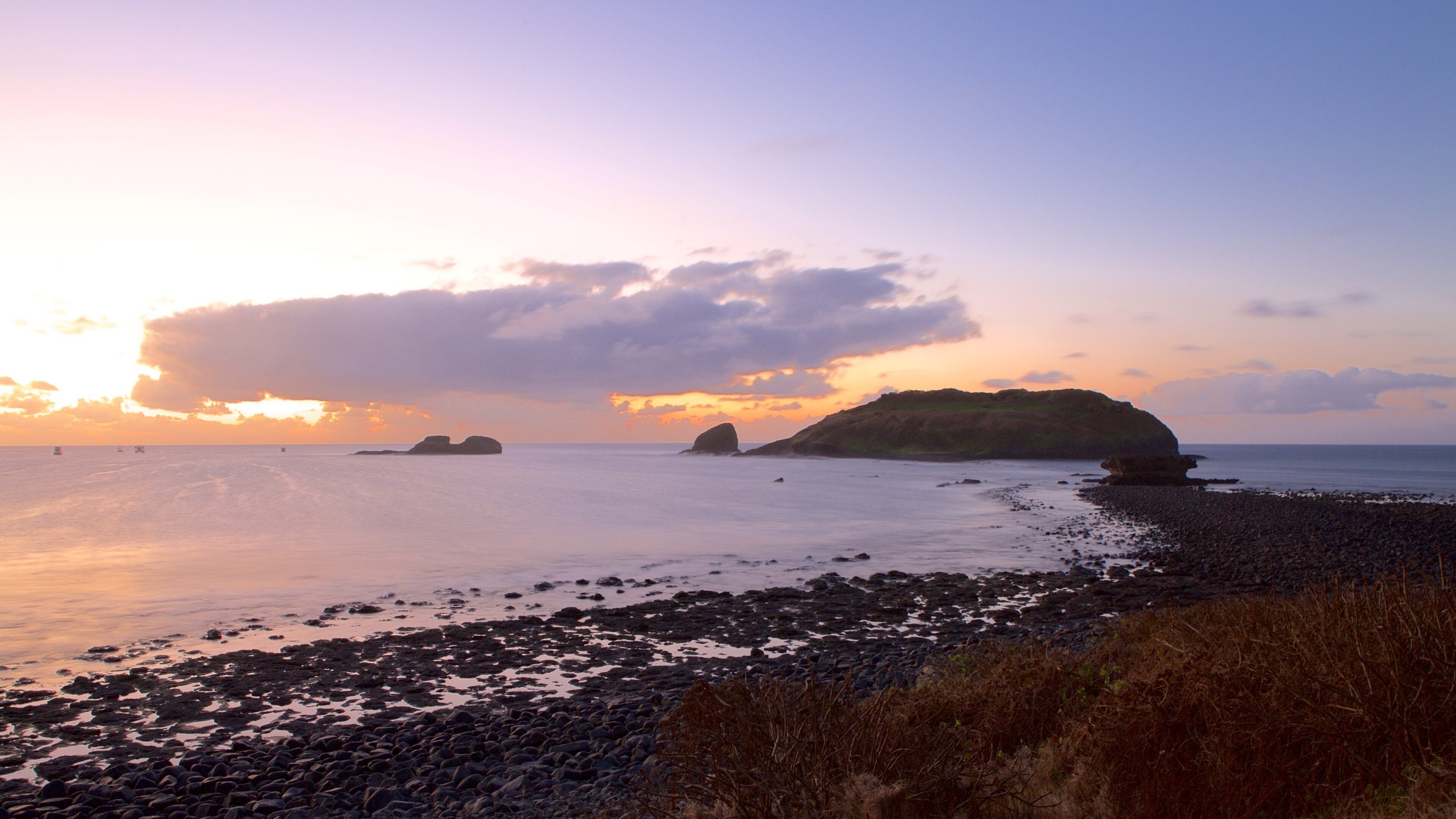Santo Antonio Port showing a sunset, a pebble beach and general coastal views