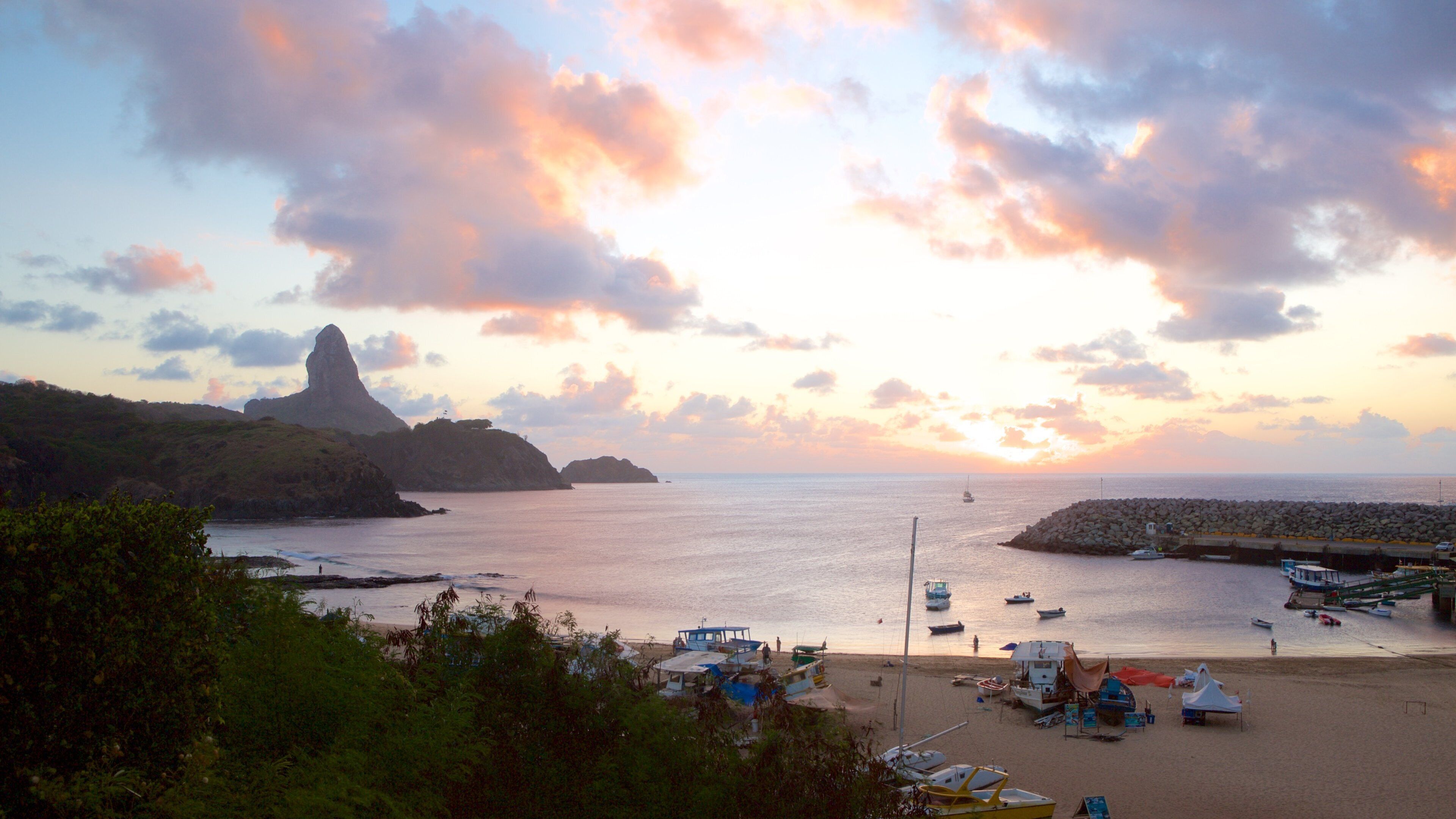 Santo Antonio Port showing general coastal views, a sandy beach and a sunset