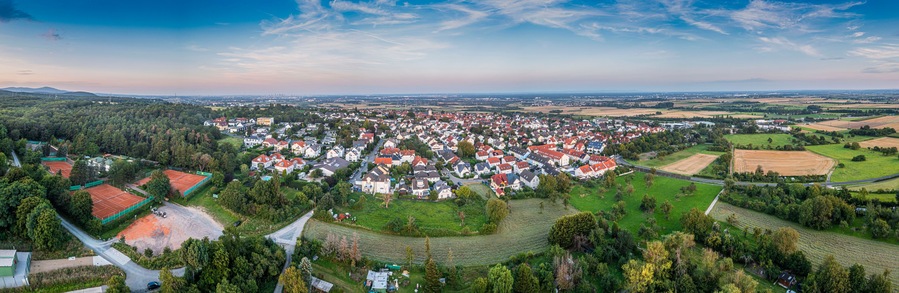 Drone panorama over German southern Hessian settlement Diedenbergen near Wiesbaden in evening light
