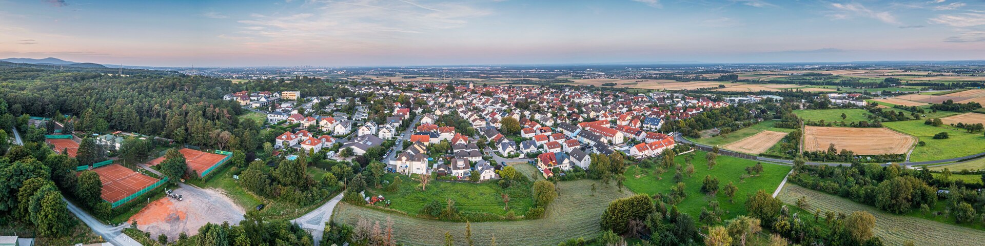 Drone panorama over German southern Hessian settlement Diedenbergen near Wiesbaden in evening light
