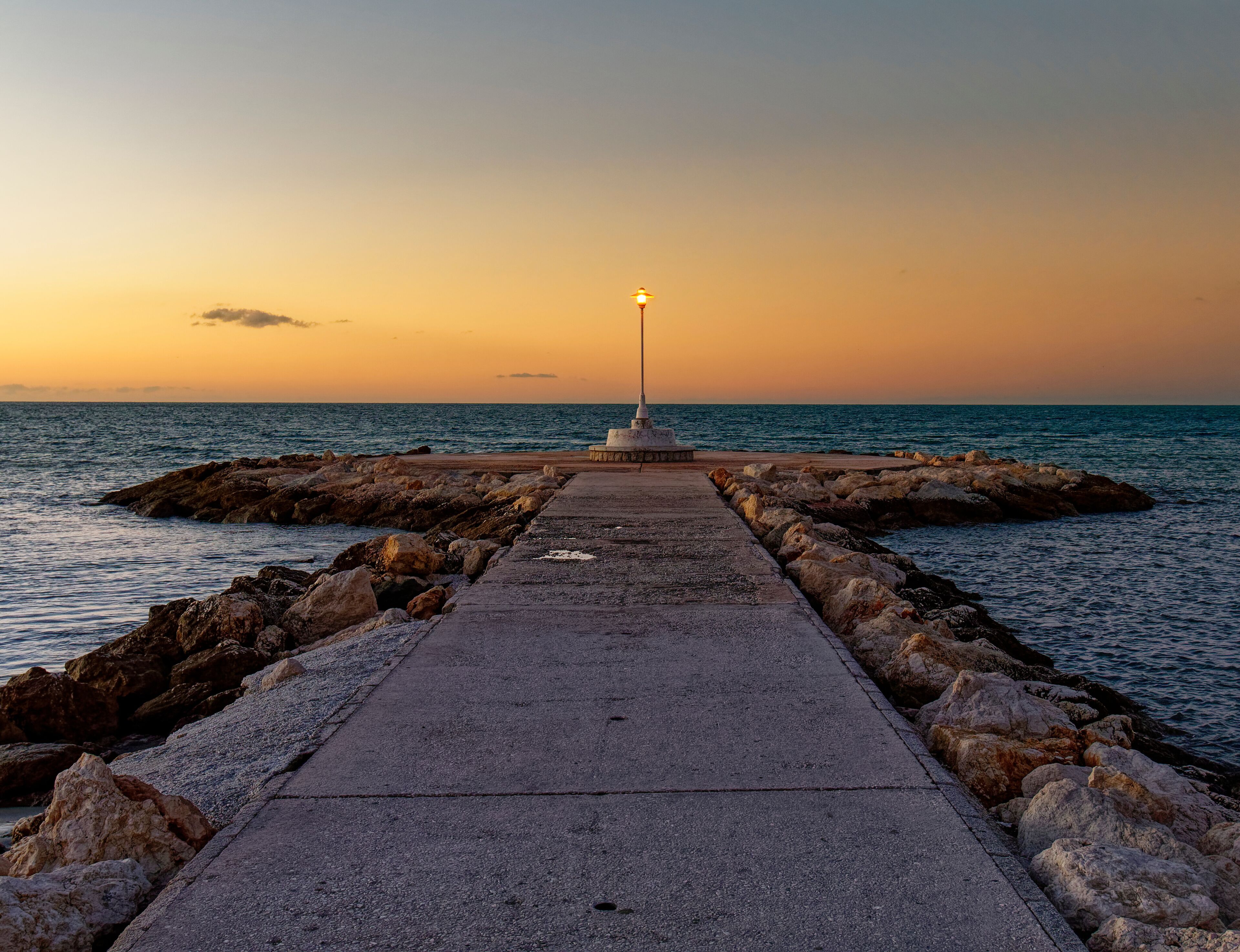 view of the sea and Lamppost on the Pedregalejo Beach at dusk