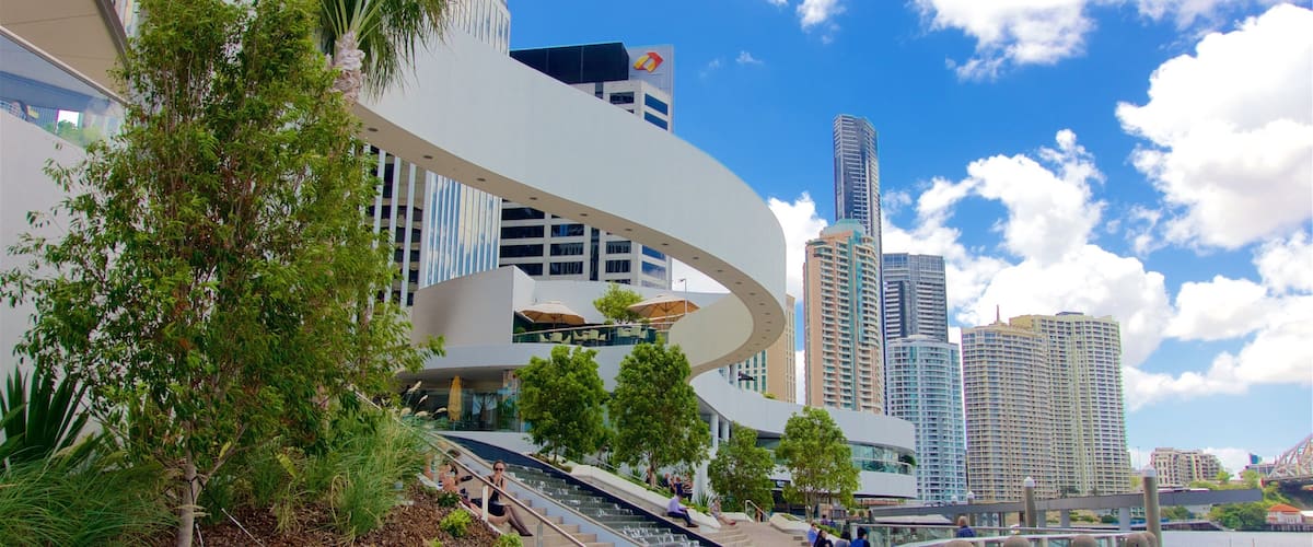 Eagle Street Pier which includes a city, a high rise building and a river or creek