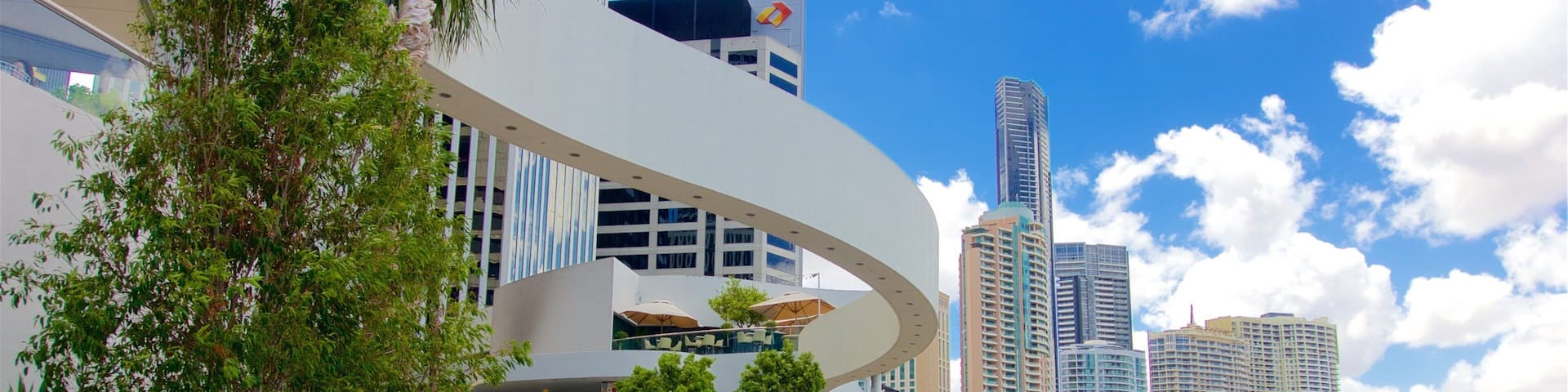 Eagle Street Pier which includes a city, a high rise building and a river or creek