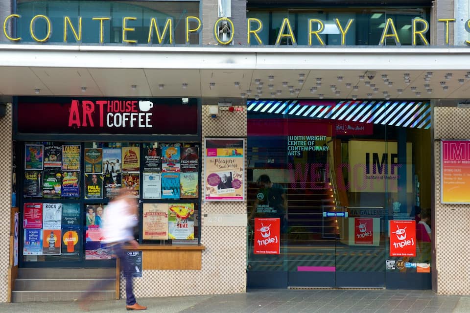 A building with a sign for 'Contemporary Arts' and 'Art House Coffee'.