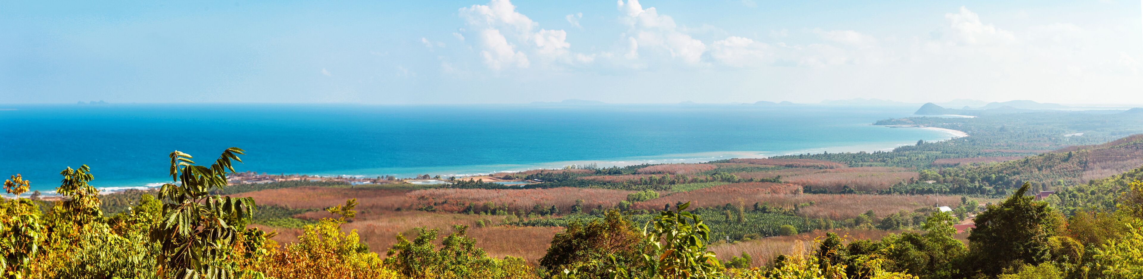 Viewpoint on Chumphon coastline from Buddha gold statue at Wat Khao Chedi-Phra Yai temple located on top of hill, Pathio, Chumphon district, Thailand
